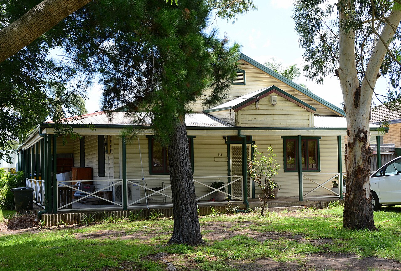 A tired weatherboard cottage with a front verandah